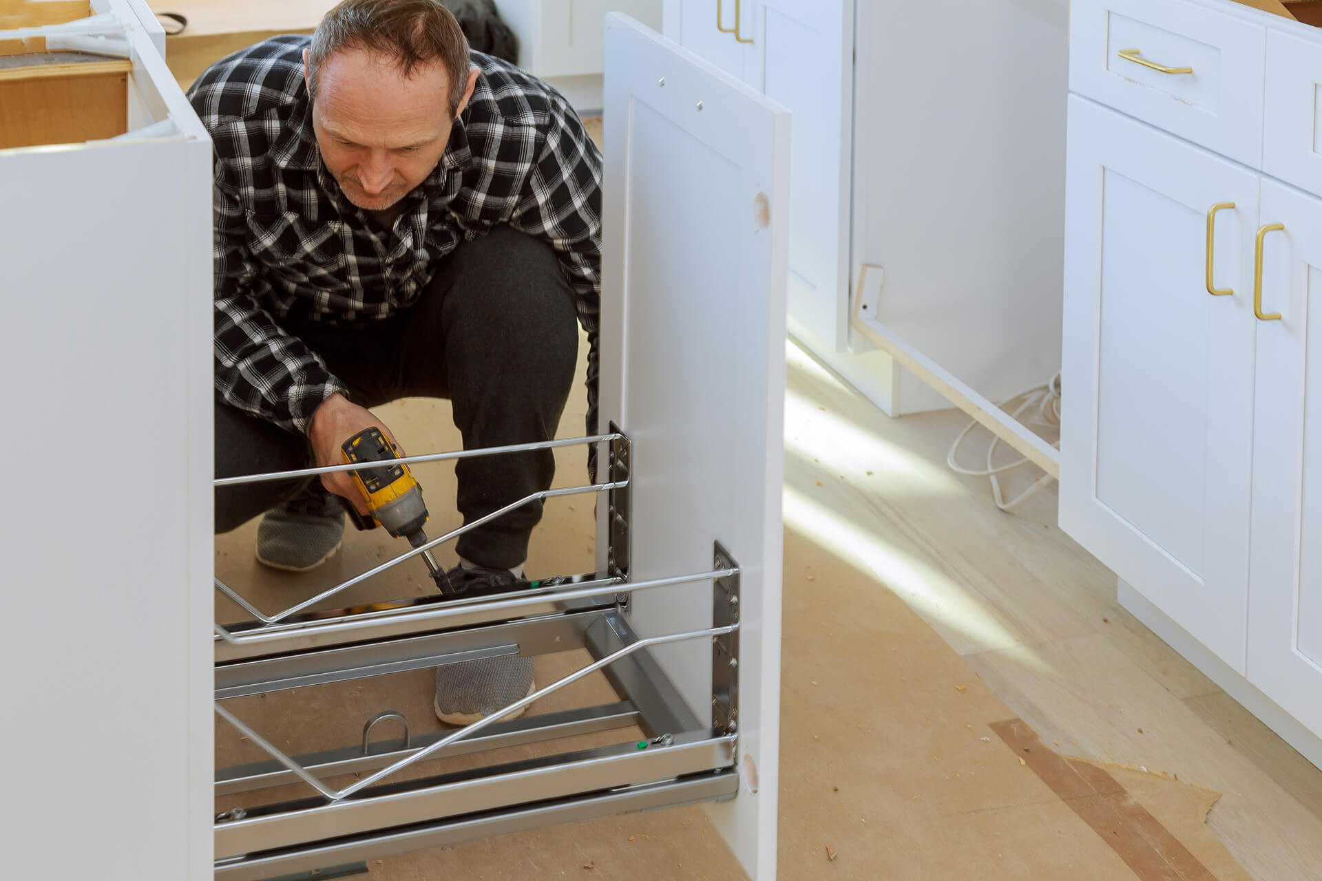 Carpenter is building drawers garbage bin kitchen