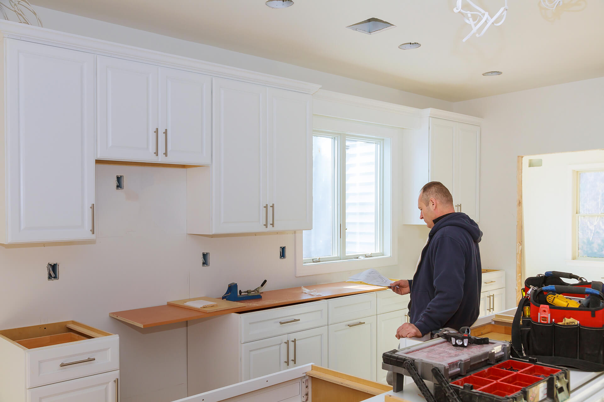 Installing new modern kitchen cabinet