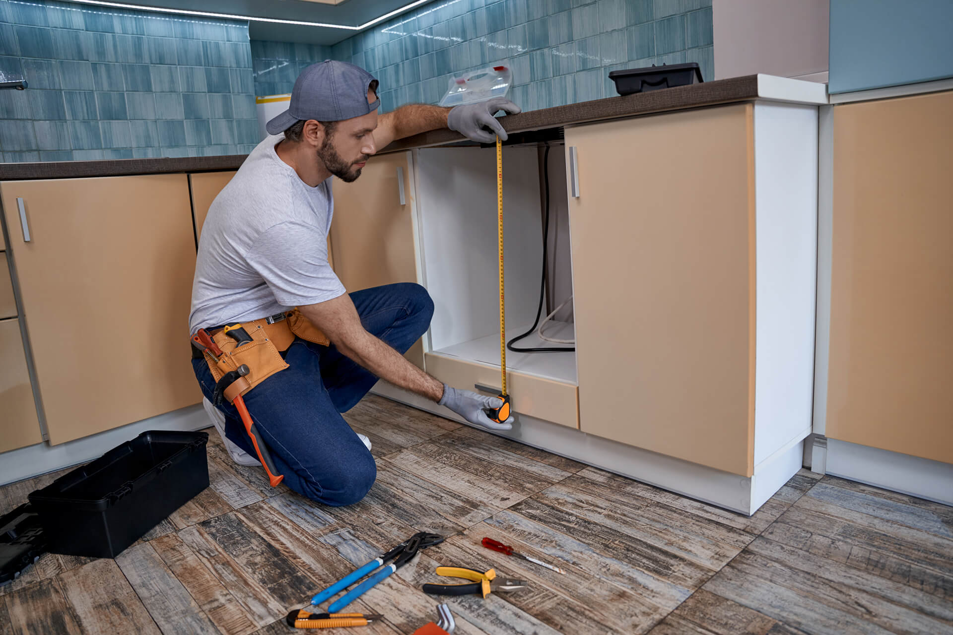Young man measuring height kitchen drawer